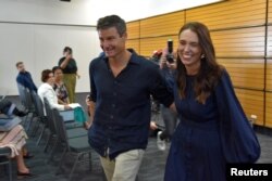 New Zealand Prime Minister Jacinda Ardern leaves with longtime partner Clarke Gayford following the announcement of her resignation at the War Memorial Hall, in Napier, New Zealand January 19, 2023. (AAP Image/Ben McLay via REUTERS)