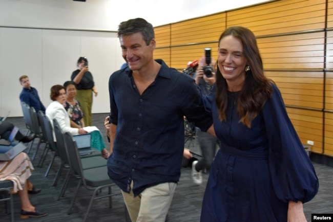 New Zealand Prime Minister Jacinda Ardern leaves with longtime partner Clarke Gayford following the announcement of her resignation at the War Memorial Hall, in Napier, New Zealand January 19, 2023. (AAP Image/Ben McLay via REUTERS)