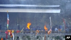 Relatives and friends perform last rites of the plane crash victims in Pokhara, Nepal, Jan. 18, 2023. 