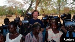 FILE - U.S. development worker John Granville, center, is pictured in this undated photo from the U.S. Agency for International Development, released Aug. 8, 2008. Granville and a colleague were shot to death in Sudan in 2008.