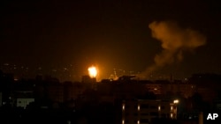 Fire and smoke rises following an Israeli airstrike in central Gaza Strip, Jan. 27, 2023. 
