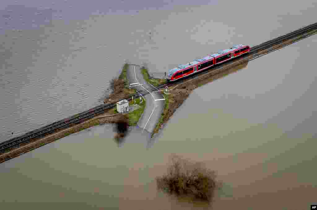 A regional train approaches a railroad crossing in Nidderau-Eichen near Frankfurt, Germany.