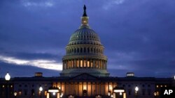 ARCHIVO - La luz en la cúpula del Capitolio se enciende, lo que indica que el trabajo continúa en el Congreso, en Washington, el 6 de octubre de 2021.