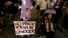 A man carries a placard at an Invasion Day rally in Sydney, Jan. 26, 2023. 