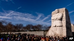 A large group gathers to watch a wreath-laying ceremony at the Martin Luther King Jr. Memorial on Martin Luther King Jr. Day in Washington, Jan. 16, 2023. 