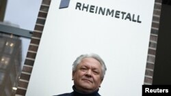 Armin Papperger, CEO of German defense and automotive group Rheinmetall AG poses in front of the company's logo following a Reuters interview in Duesseldorf, Germany, Jan. 27, 2023.