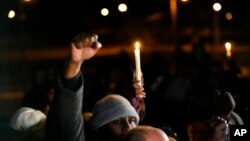 People attend a candlelight vigil for Tyre Nichols, who died after being beaten by Memphis police officers, in Memphis, Tenn., Jan. 26, 2023.