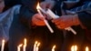 Women light candles during a prayer ceremony for victims of a suicide bombing inside a mosque, in Peshawar, Pakistan, Feb. 1, 2023.