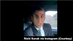 British Prime Minister Rishi Sunak appears to not be wearing his seat belt in a travelling car.