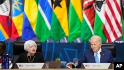 FILE - President Joe Biden listens as Treasury Secretary Janet Yellen, left, speaks during the closing session at the U.S.-Africa Leaders Summit on promoting food security and food systems resilience in Washington, Dec. 15, 2022.