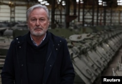 Freddy Versluys, the CEO of Belgian defense company OIP Land Systems, looks on near armored vehicles in a hangar in Tournais, Belgium, Jan. 31, 2023.