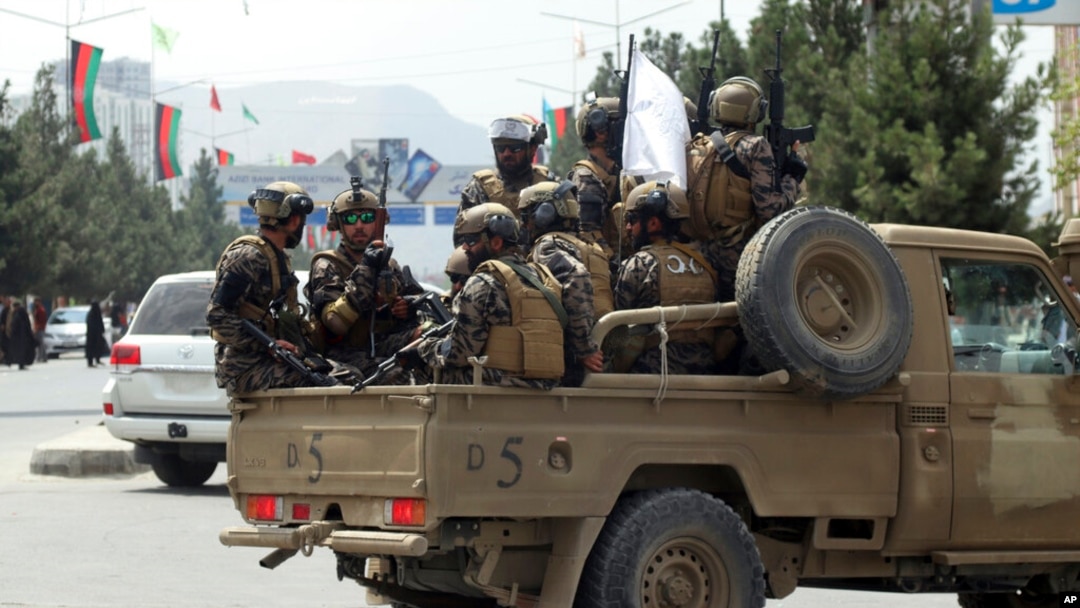 FILE - Taliban fighters arrive at Kabul airport, Aug. 31, 2021. 