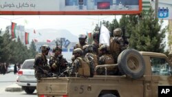 FILE - Taliban fighters arrive at Kabul's airport, Aug. 31, 2021. 