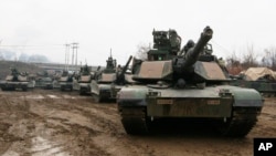 FILE - In this Dec. 10, 2015, file photo, U.S. M1A2 SEP Abrams battle tanks prepare to cross the Hantan river during an operation, part of an annual joint military exercise between South Korea and the United States. (AP Photo/Ahn Young-joon, File)