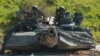 FILE - U.S. soldiers in an M1 Abrams tank conduct vehicle movements as part of an exercise at the Hohenfels Training Area, Germany, June 2, 2022.