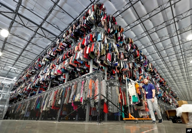Ribuan pakaian disimpan pada sistem konveyor tiga tingkat di fasilitas penyortiran ThredUp di Phoenix, Arizona, AS, 12 Maret 2019. (AP/Matt York, File)