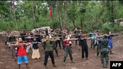 FILE - Members of the People's Defense Force, the armed wing of the civilian National Unity Government opposed to Myanmar's ruling military regime, take part in training at a camp in Kayin State, near the Myanmar-Thai border, Oct. 9, 2021.