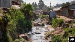 FILE: A tributary full of garbage, which feeds into the Nairobi River, flows through the informal settlement of Kibera in Nairobi, Kenya is noted on World Water Day, March 22.. Taken Wed, Jan. 11, 2023.
