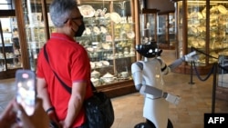 FILE - A photo shows the robot R1, designed by the Italian Institute of Technology, guiding tourists at the Palazzo Madama museum in Turin, May 12, 2021. The robot is able to describe the works and answer questions relating to the author or the historical period to which they belong.