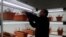 A scientist conducts an experiment related to corm production inside under controlled conditions at Advanced Research Station for Saffron and Seed Spices in Pampore, on the Indian side of Kashmir. (Wasim Nabi for VOA)