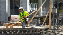 FILE - People work at a construction site in Miami, Jan. 24, 2023.