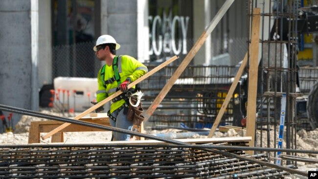 FILE - People work at a construction site in Miami, Jan. 24, 2023.