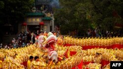 A 238m-long dragon dance is performed in front of the A-Ma Temple during celebrations on the first day of the Chinese lunar new year in Macau, China, Jan. 22, 2023.