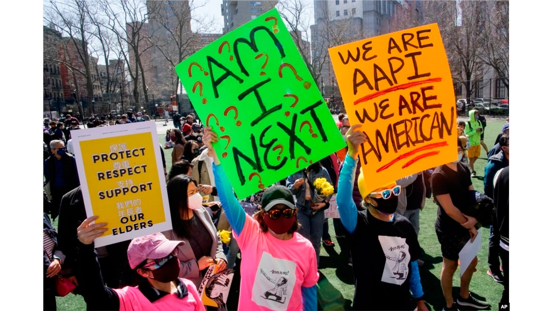FILE- People take part in a rally against hate and confront the rising violence against Asian Americans at Columbus Park in New York's Chinatown on March 21, 2021.