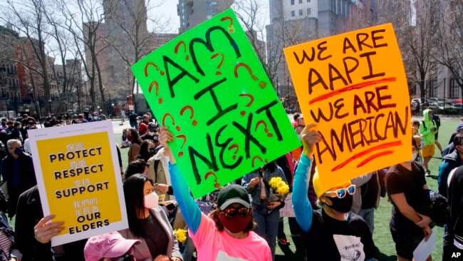 FILE - People take part in a rally against hate and confront the rising violence against Asian Americans at Columbus Park in New York's Chinatown on March 21, 2021.