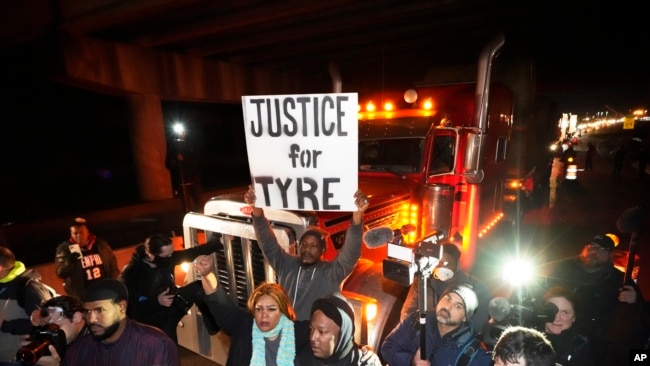 Protesters march down the street on Jan. 27, 2023, in Memphis, Tennessee, as authorities release police video depicting five Memphis officers beating Tyre Nichols.