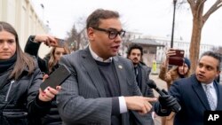 Congressman George Santos responds to reporters' questions as he leaves a House Republican conference meeting on Capitol Hill in Washington, Jan. 25, 2023. 