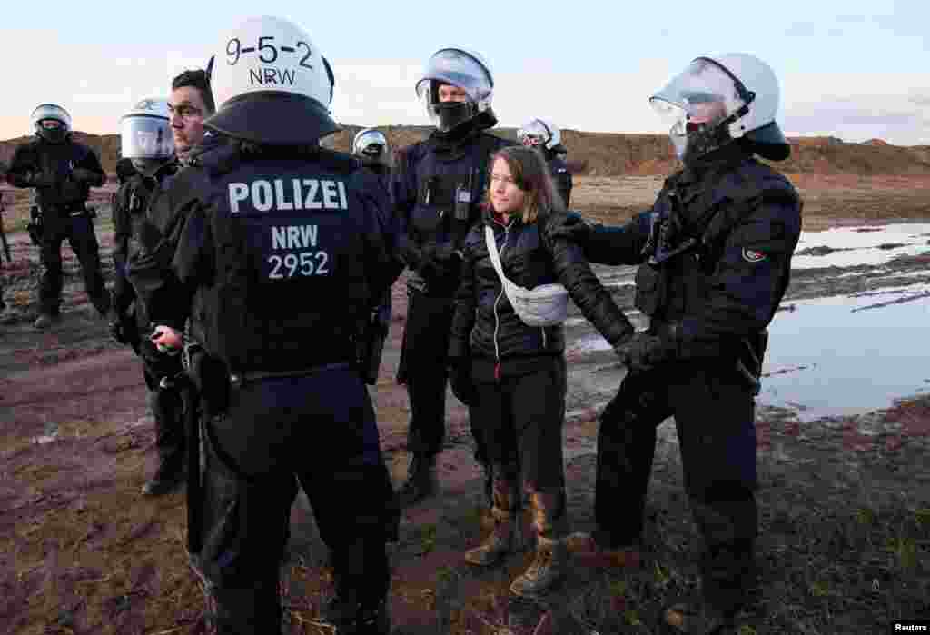 Police officers detain climate activist Greta Thunberg during a protest against the expansion of the Garzweiler open-cast lignite mine of Germany&#39;s utility RWE to Luetzerath, in Germany.