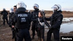 Police officers detain climate activist Greta Thunberg during a protest against the expansion of the Garzweiler open-cast lignite mine of Germany&#39;s utility RWE to Luetzerath, in Germany.