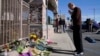 FILE - Kenny Loo, 71, prays outside Star Ballroom Dance Studio for the victims killed in Saturday's shooting in Monterey Park, Calif., Jan. 23, 2023.
