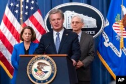 FBI Director Christopher Wray, with Deputy Attorney General Lisa Monaco and Attorney General Merrick Garland, speaks during a news conference at the Justice Department in Washington, Jan. 26, 2023.