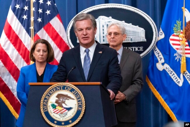 FBI Director Christopher Wray, with Deputy Attorney General Lisa Monaco and Attorney General Merrick Garland, speaks during a news conference at the Justice Department in Washington, Jan. 26, 2023.