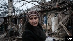 Lidiya Malyovana, 76, reacts at her house destroyed by a rocket overnight as the sounds of gunshots and artillery continue in the distance in Chasiv Yar, Donetsk region, Ukraine, on Jan. 28, 2023. 