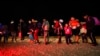 Migrants wait to be processed after crossing the U.S. border. Jan. 6, 2023, near Yuma, Ariz.