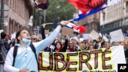 Anti-vaccine protesters march during a rally in Strasbourg, France, July 17, 2021. Tens of thousands of people protested across France on Saturday against the government's latest measures to curb rising COVID-19 infections.