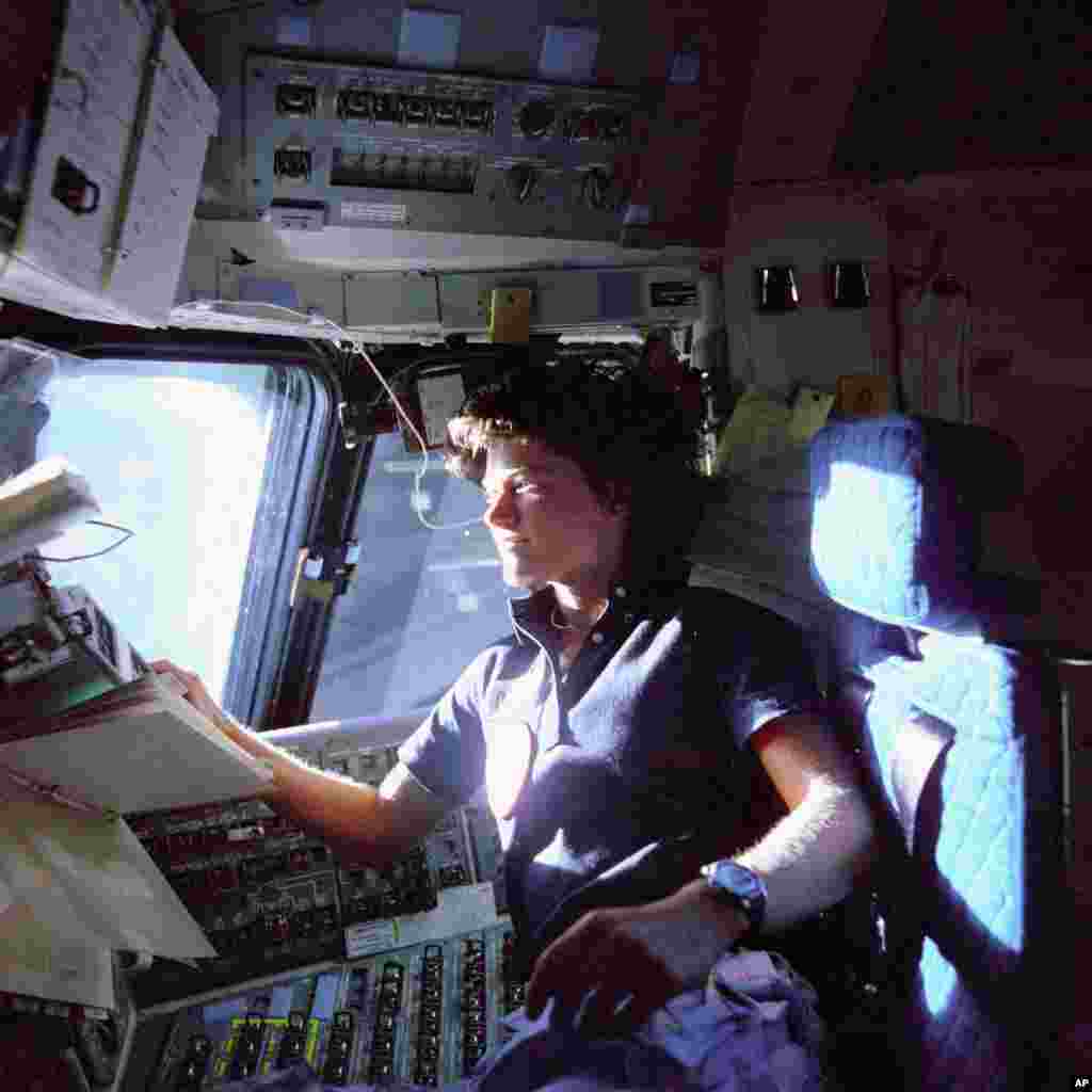 1983: Astronaut Sally K. Ride, the first woman to orbit the earth. Here she monitors control panels from the pilot's chair on the Flight Deck on STS-7, where she was mission specialist.