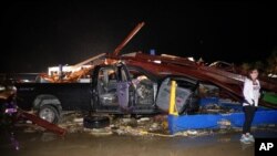 Ernestine Cook of Canton, Texas, inspects the damage to the Dodge dealership after a tornado hit Canton, Texas, April 29, 2017. Authorities say fatalities have been reported and dozens of people were taken to hospitals after a tornado hit the small city 