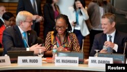 Actor Matt Damon, right, is welcomed to a meeting to promote his organization for universal clean water and sanitation, by former Australian Prime Minister Kevin Rudd, left, and Swaziland's Minister of Natural Resources and Energy Jabulile Mashwama, as part of the IMF and World Bank's 2017 Annual Spring Meetings, in Washington, April 20, 2017. 