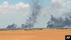 This June 8, 2016 video grab shows smoke rising from the city of Manbij, Syria.