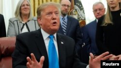 President Donald Trump speaks in the Oval Office at the White House in Washington, Feb. 19, 2019. 