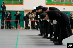 Nuns bow at a memorial to the plane crash victims in Muan, South Korea, Dec. 30, 2024.