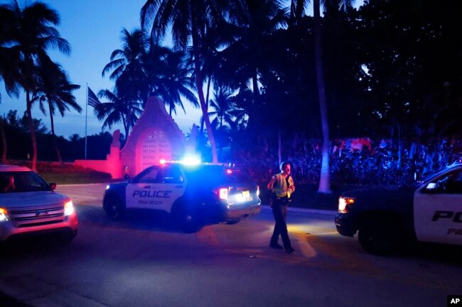 Police direct traffic outside an entrance to former President Donald Trump's Mar-a-Lago estate, in Palm Beach, Fla., Aug. 8, 2022. (AP Photo/Terry Renna)