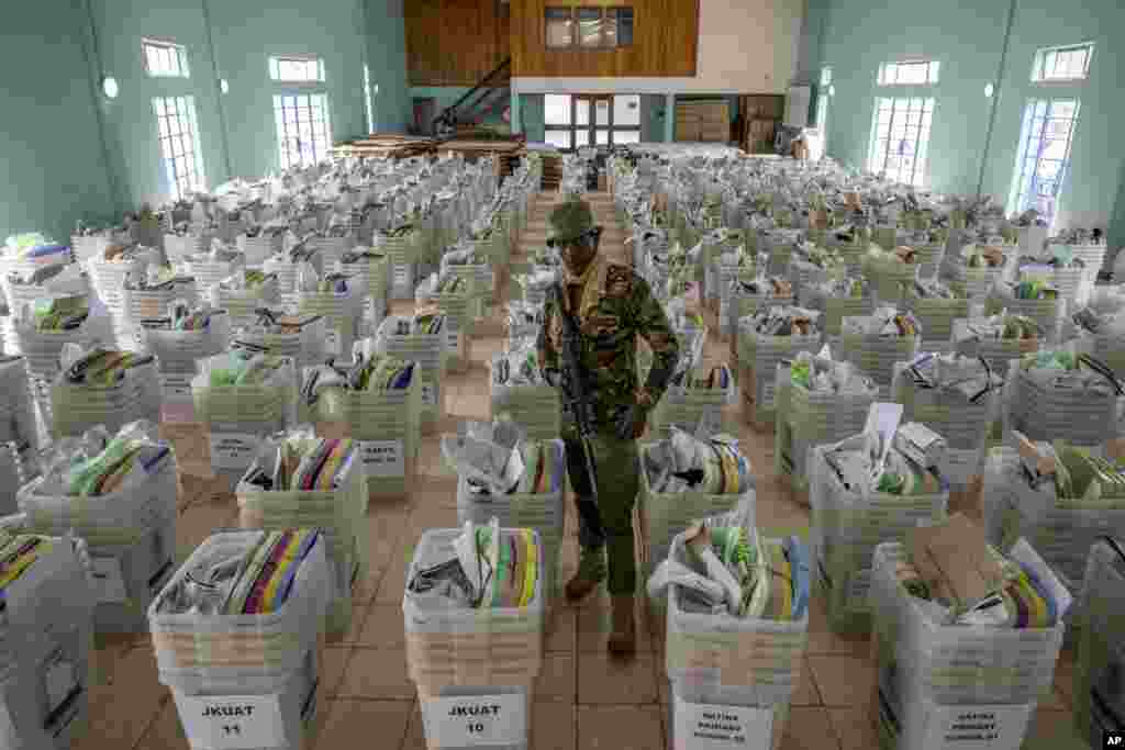 A policeman guards voting boxes and election materials to be given polling stations, at a counting center in Nairobi, Kenya.&nbsp;Kenya is voting on Aug. 9, 2022, in an election that will bring East Africa&#39;s economic center a new president after 10 years.&nbsp;