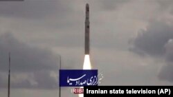 This image taken from video footage aired by Iranian state television on Nov. 5, 2022, shows the launch of a satellite carrier rocket by Iran’s Revolutionary Guard from an undisclosed desert location. (Iranian state television via AP)