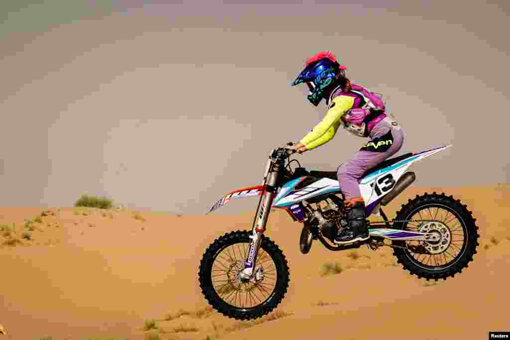 Hayley O&#39;Connor, 14, rides her dirt bike during the summer heat in the desert of Dubai, United Arab Emirates.