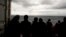 Migrants stand on the deck of the Ocean Viking rescue ship, in the Strait of Sicily, in the Mediterranean Sea, Nov. 5, 2022. 